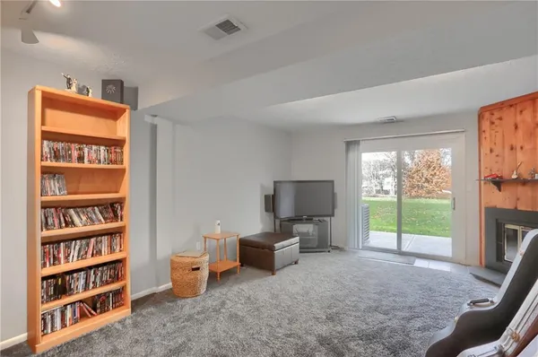 a living room with furniture a flat screen tv and a large window