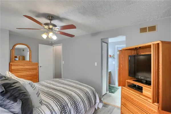 a bedroom with a bed and a chandelier