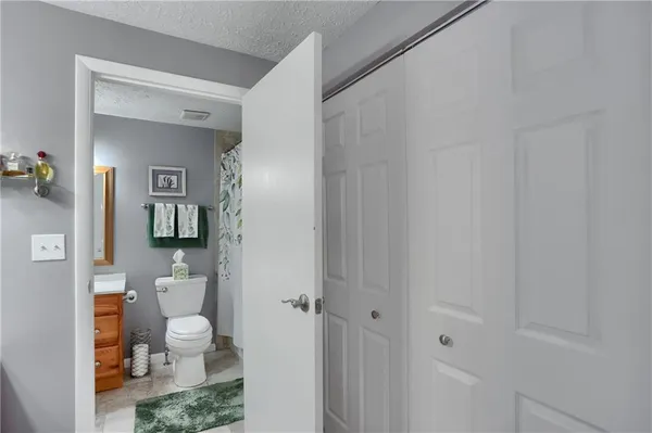 a bathroom with a sink vanity mirror and toilet