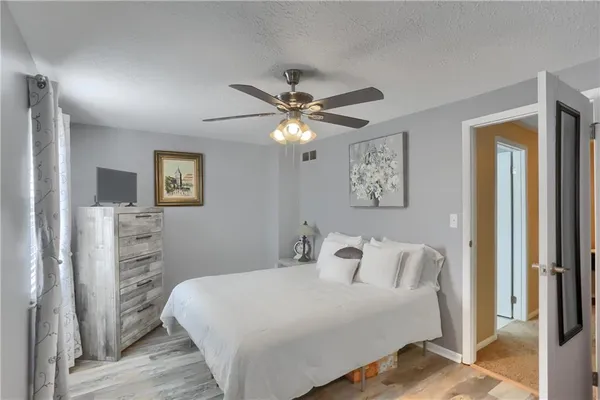 a bedroom with a bed and a chandelier