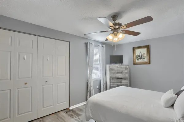 a bedroom with a bed and a chandelier