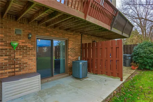 a front view of residential houses with yard and furniture