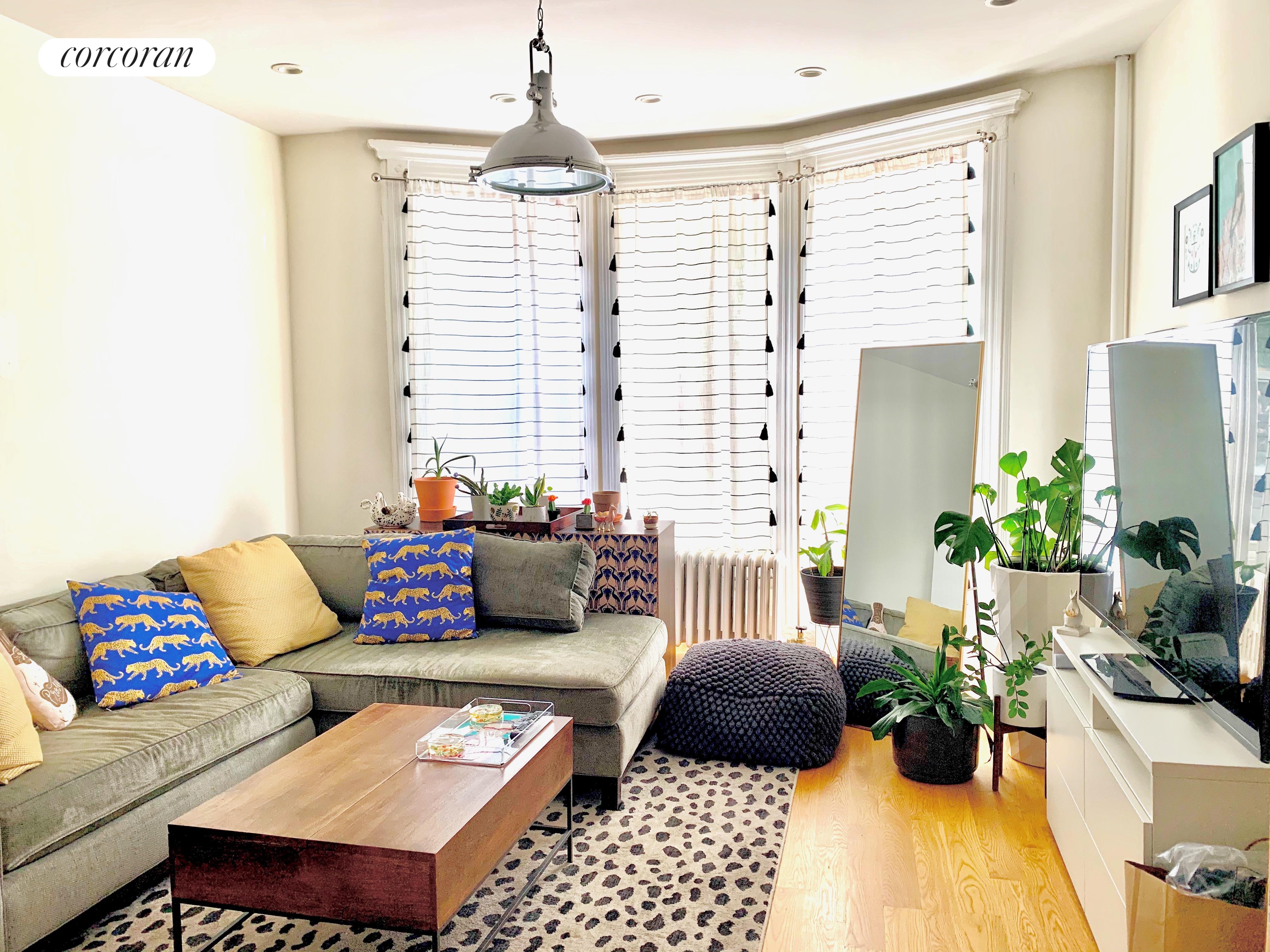 a living room with furniture and flowers