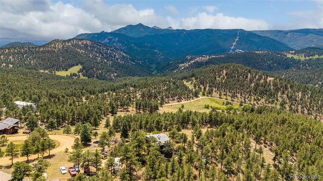 a view of mountain with sunset in background