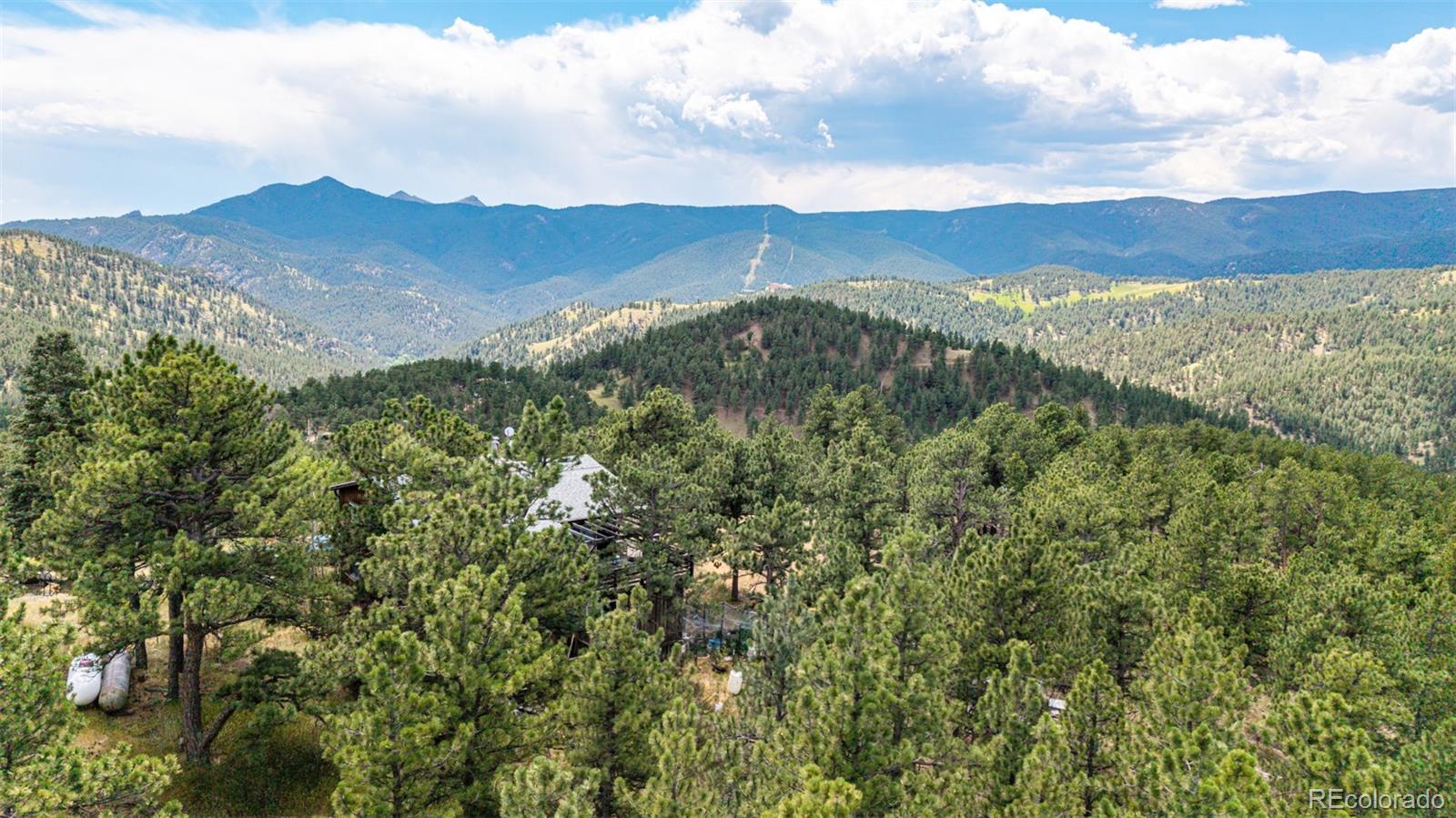 398 Leonards Road Boulder, CO 80302 - Photo 15 of 34 a view of an mountain range with lush green forest