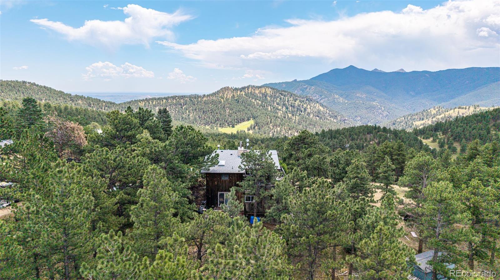 398 Leonards Road Boulder, CO 80302 - Photo 16 of 34 a view of a city with lush green forest