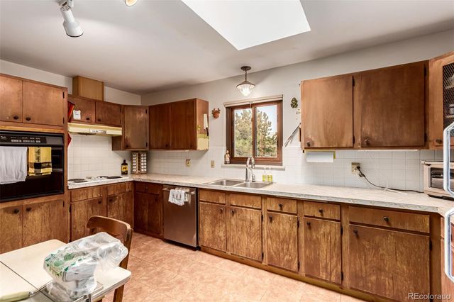 a kitchen with sink and cabinets