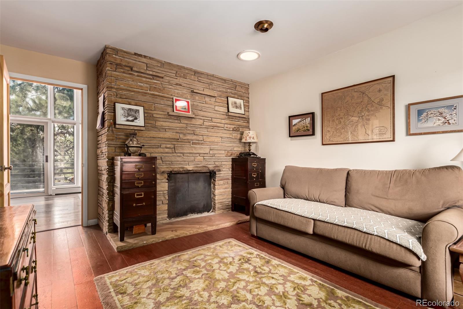 398 Leonards Road Boulder, CO 80302 - Photo 8 of 34 a living room with furniture and a fireplace