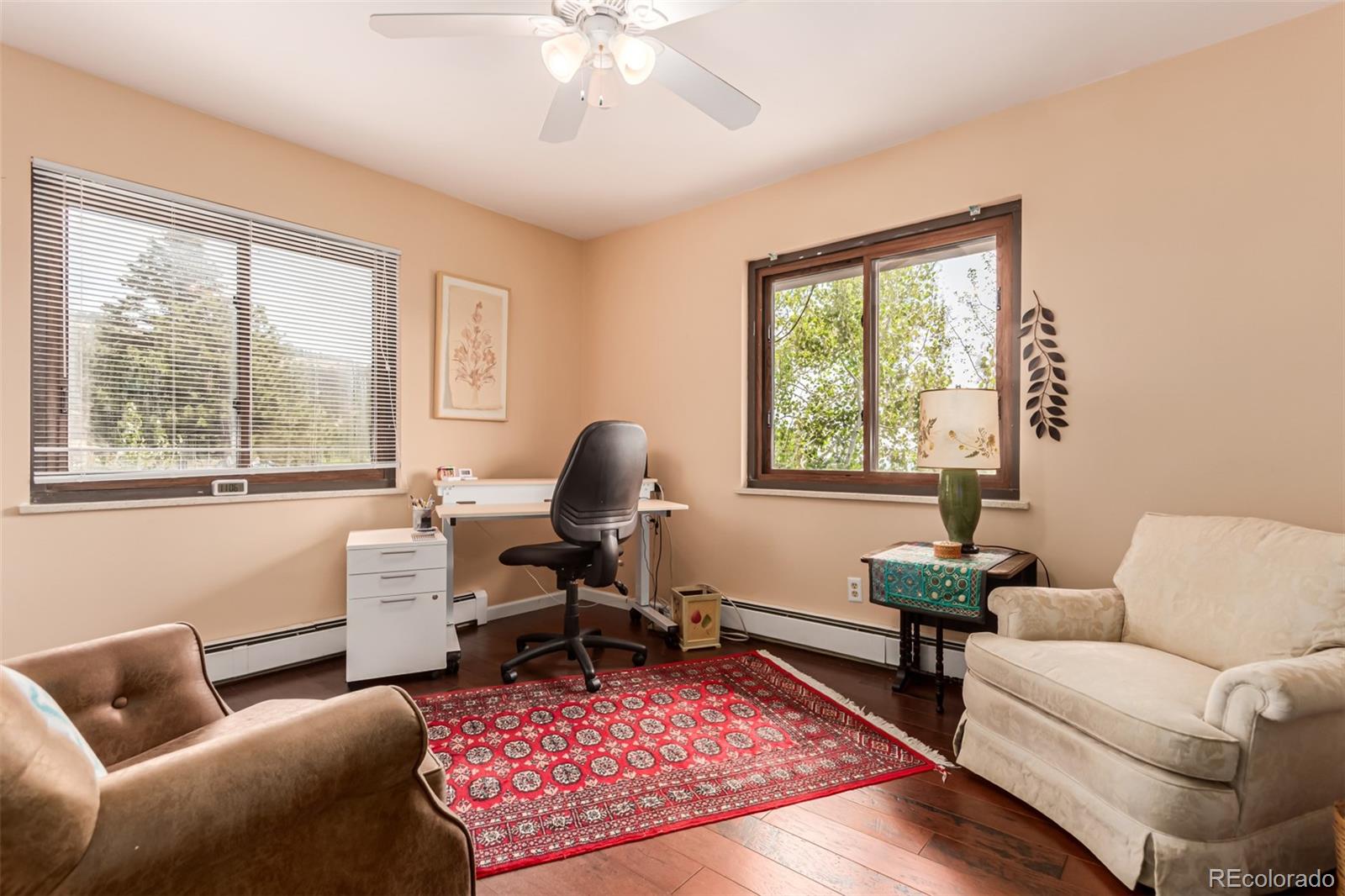 398 Leonards Road Boulder, CO 80302 - Photo 9 of 34 a living room with furniture a rug a lamp and a large window