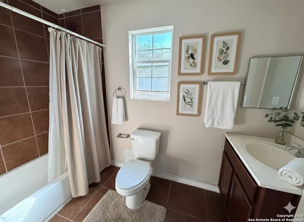 a bathroom with a toilet sink and shower