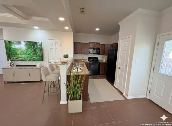 a living room with furniture a flat screen tv and floor to ceiling window