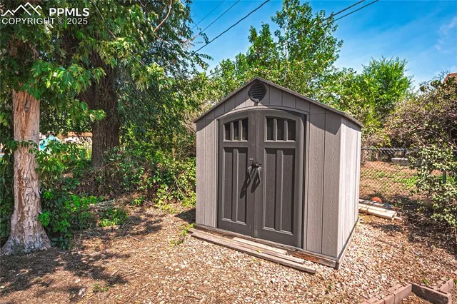 a yellow house with trees in front of it
