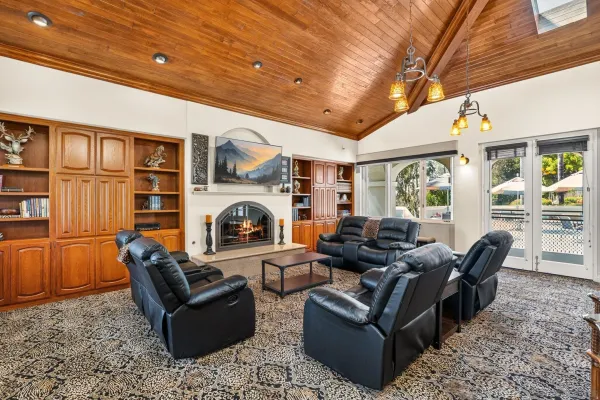 a living room with furniture a fireplace and a large window