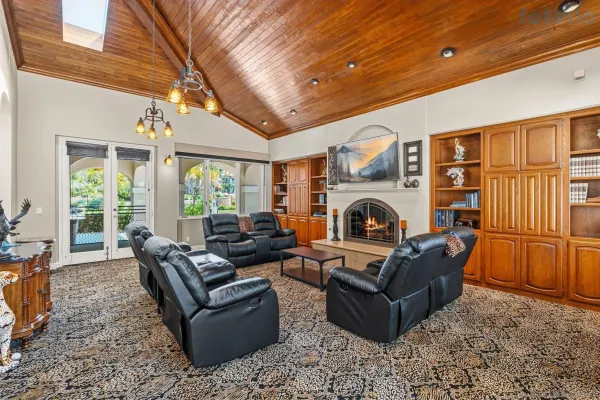 a living room with furniture fireplace and flat screen tv