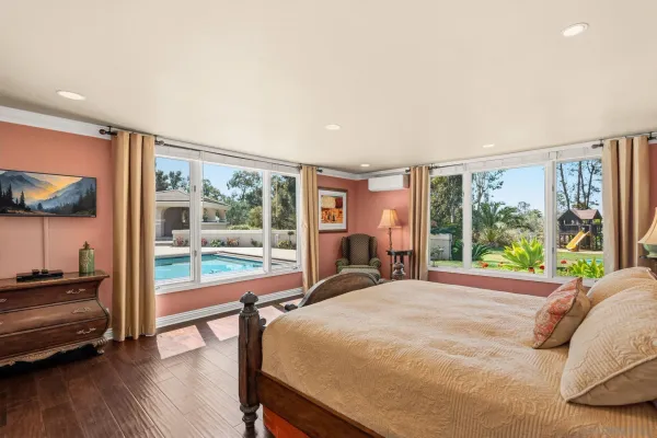 a bed sitting in a bedroom next to a window