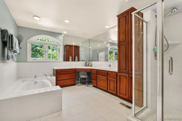 a bathroom with a tub sink and mirror
