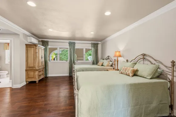 a bedroom with a bed and a large window