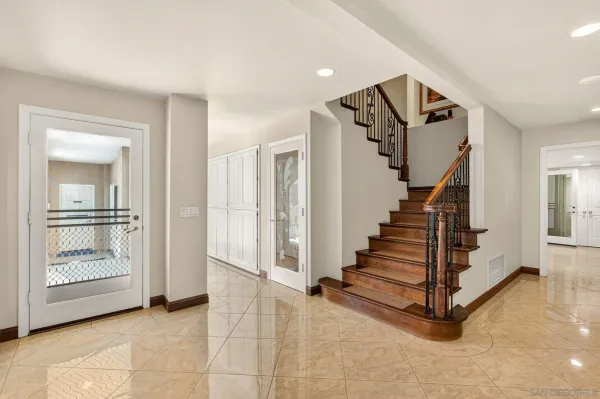 a view of entryway and hall with a front door