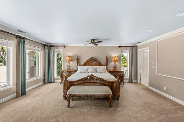 a bedroom with a bed and large window