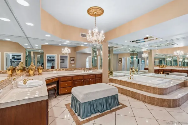 a view of a white house with a big yard and potted plants