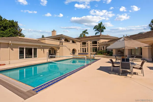 a view of a patio with swimming pool table and chairs