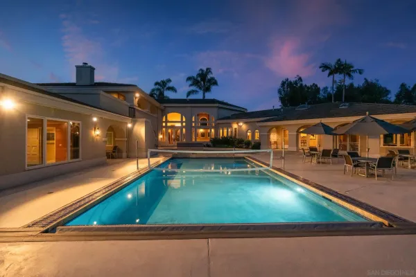a view of a hallway with furniture and a workspace