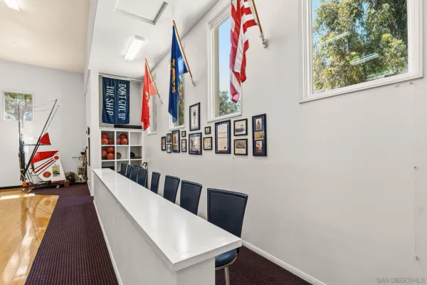 a front view of a house with a yard and potted plants