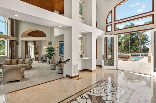 a living room with furniture and large windows