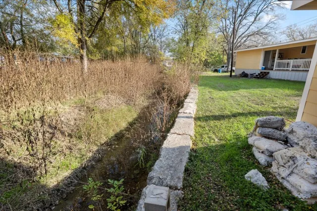 a view of a house with backyard and porch
