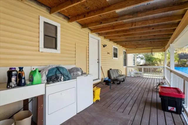 a view of patio with table and chairs and wooden floor