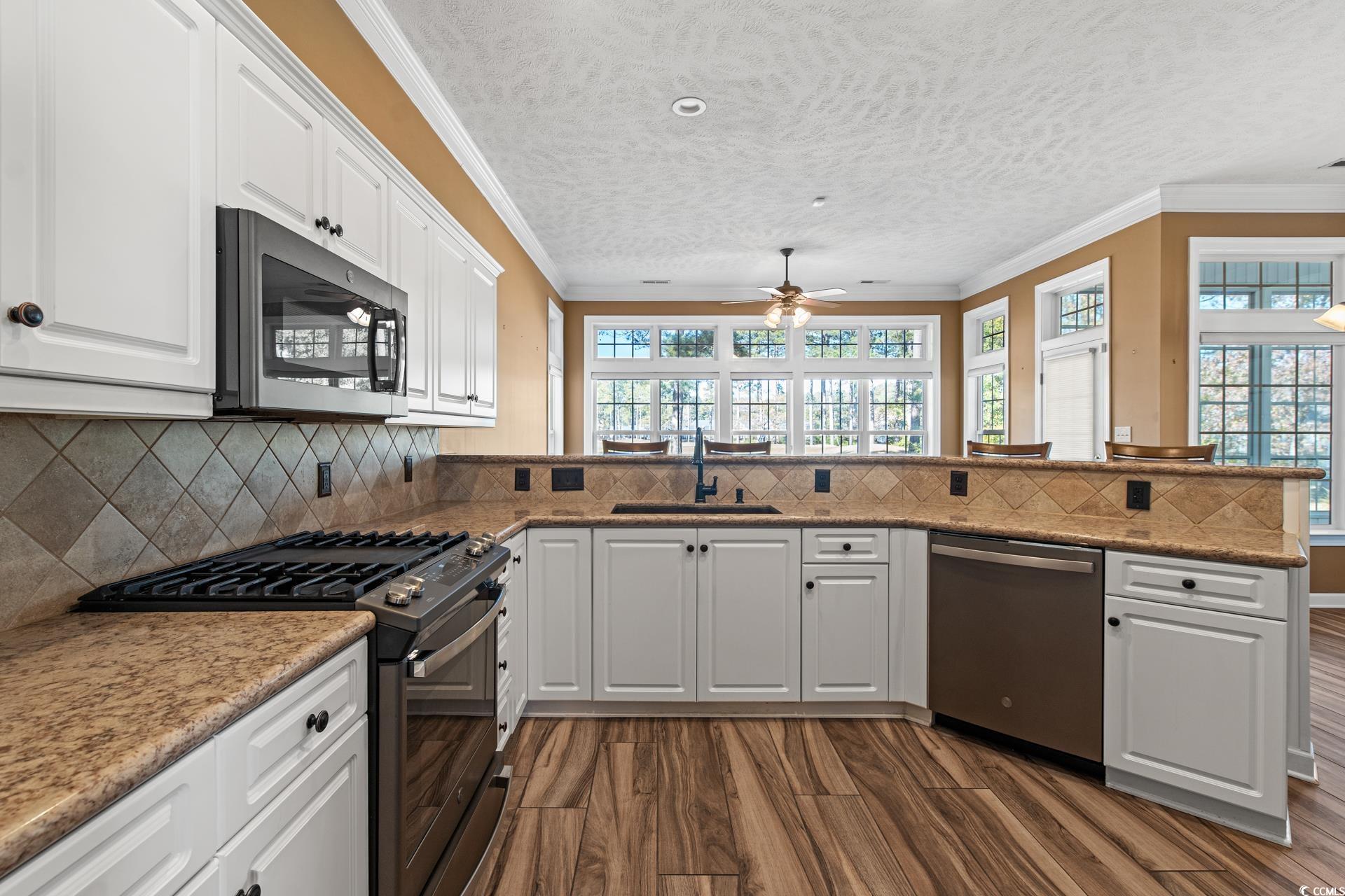 126 Pickering Drive Murrells Inlet, SC 29576 - Photo 11 of 40 Kitchen featuring ceiling fan, dark wood-type floo