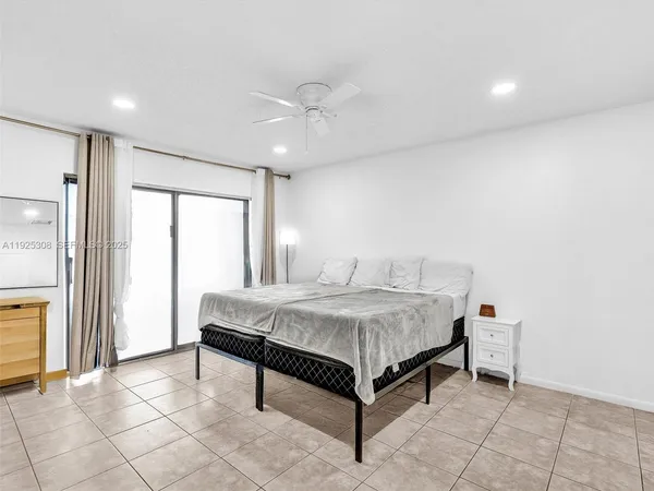 a spacious bedroom with a bed and a cabinets