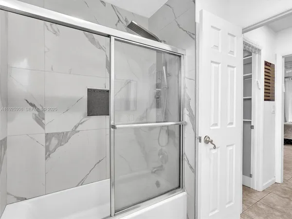 a bathroom with a glass shower door