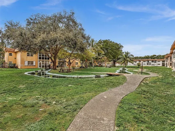 a view of a park with large trees