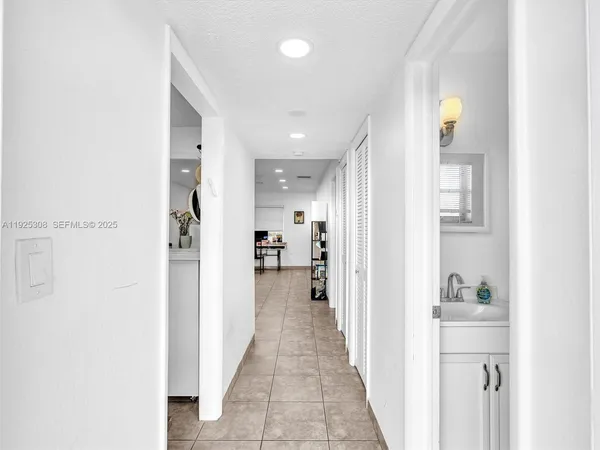 a view of a hallway with wooden shelves