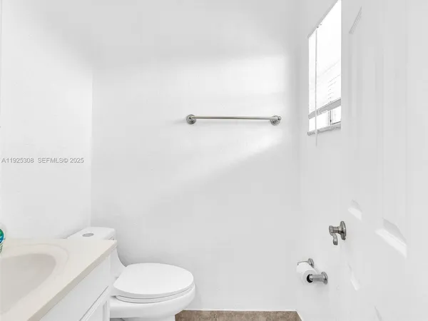 a white toilet sitting next to a bath tub