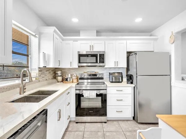 a kitchen with a refrigerator stove and sink