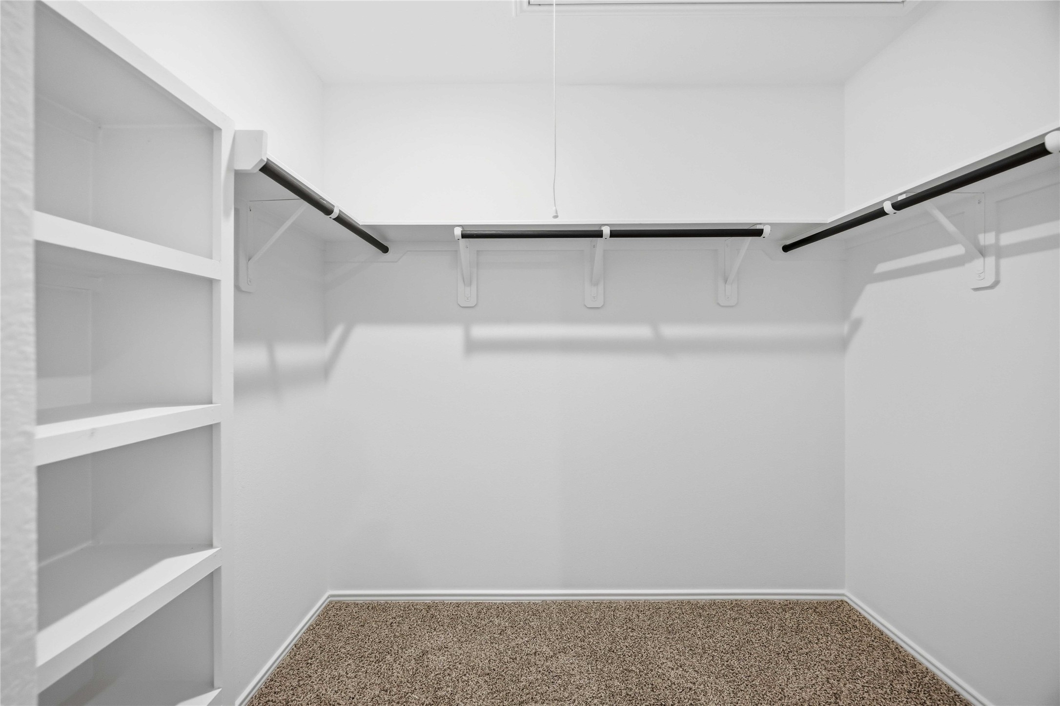 11913 Sweet Apple Lane Houston, TX 77048 - Photo 15 of 20 a view of walk in closet with empty racks