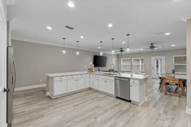 a kitchen with a sink microwave and cabinets