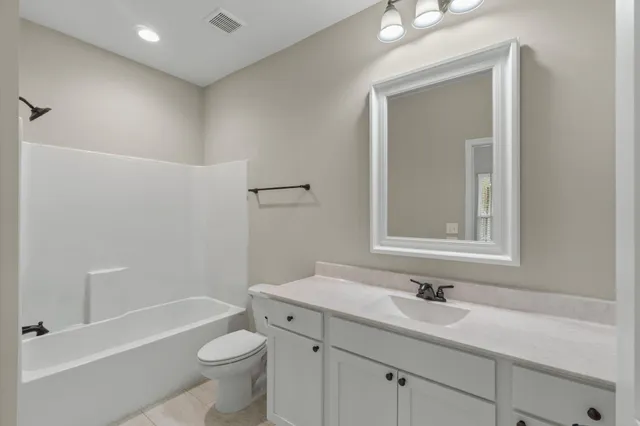 a bathroom with a sink a toilet and a bathtub