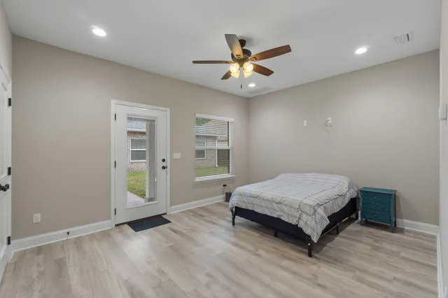 a living room with a bed furniture and a window