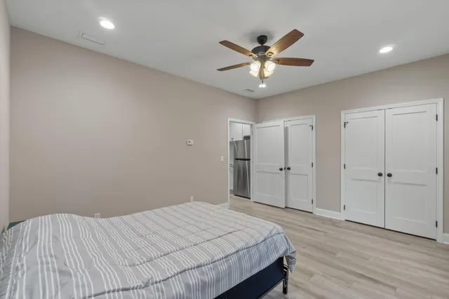 a bedroom with a large bed and a chandelier