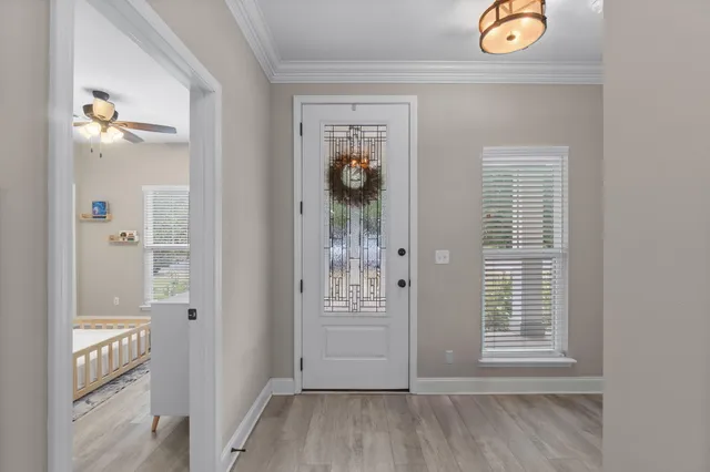 a view of an entrance and a livingroom with furniture
