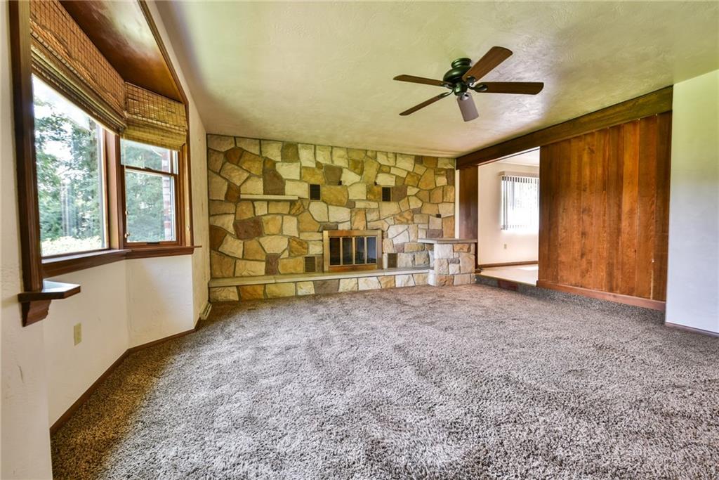 2337 Nicholson Road Franklin Park, PA 15143 - Photo 4 of 25 The oversized living room has plenty of natural light, stone fireplace and is topped off by a ceiling fan.