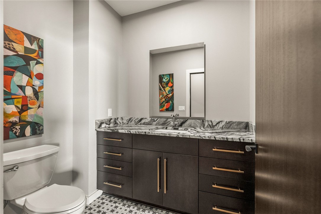 2623 Alum Cave Road Bee Branch, AR 72013 - Photo 50 of 60 Dark wood-finish vanity featuring a stone countertop, an undermount sink, and brass hardware