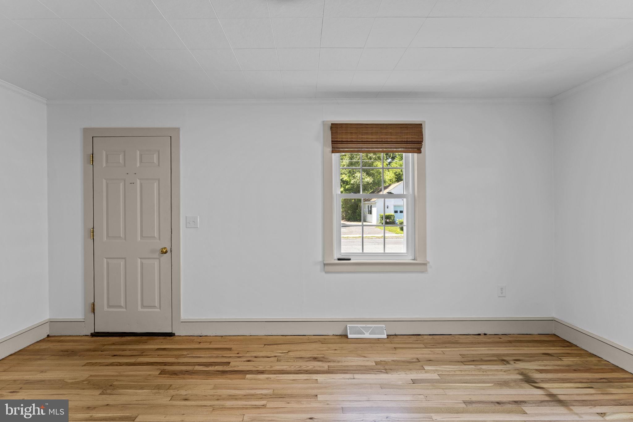 216 Walnut Street Berryville, VA 22611 - Photo 8 of 36 a view of an empty room with window and wooden floor