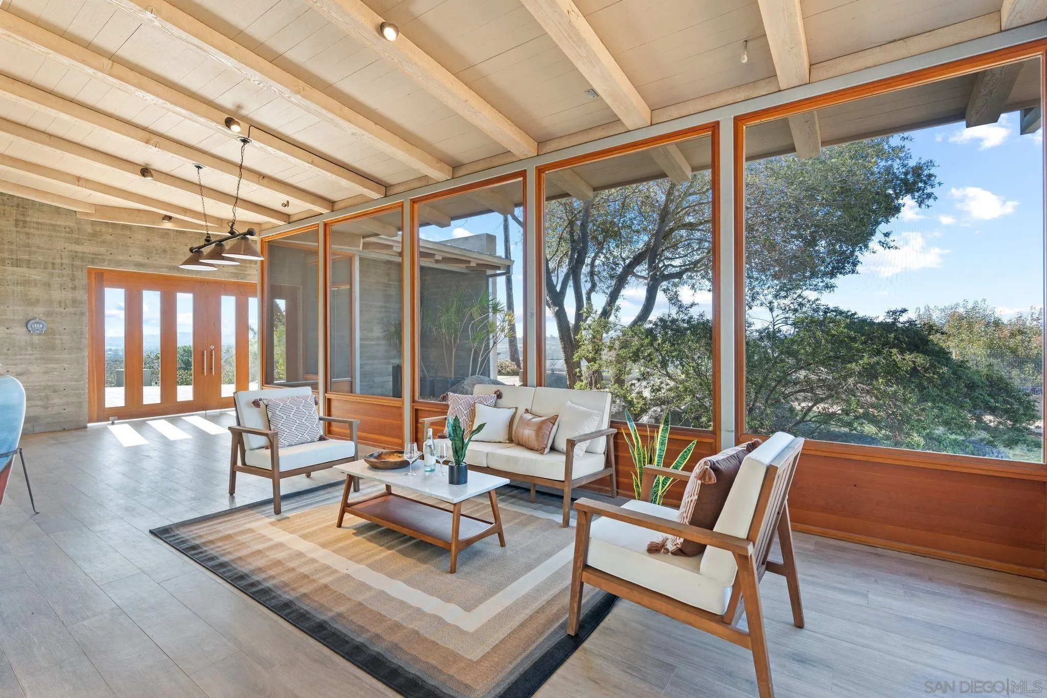 20385 Rancho Villa Road Ramona, CA 92065 - Photo 6 of 25 a living room with patio furniture and a floor to ceiling window