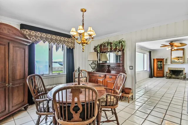 a view of a dining room with furniture wooden floor and chandelier
