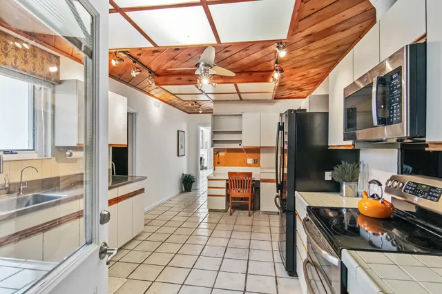 a kitchen with stainless steel appliances granite countertop a stove and a refrigerator