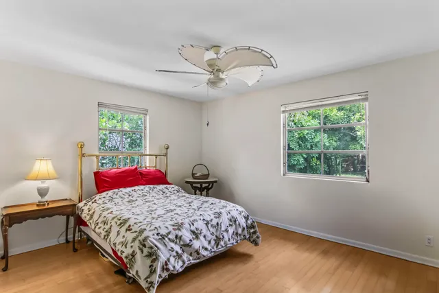 a bedroom with a large bed and a window